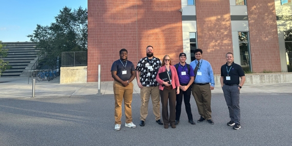 MGA’s Collegiate Penetration Testing Competition team was made up of students (l-r in image) Coby Roye, Ben Behnke, Stephanie James (captain), Damian Allen, and Dylan Eddie, with coach Dr. Alan Stines (far right).
